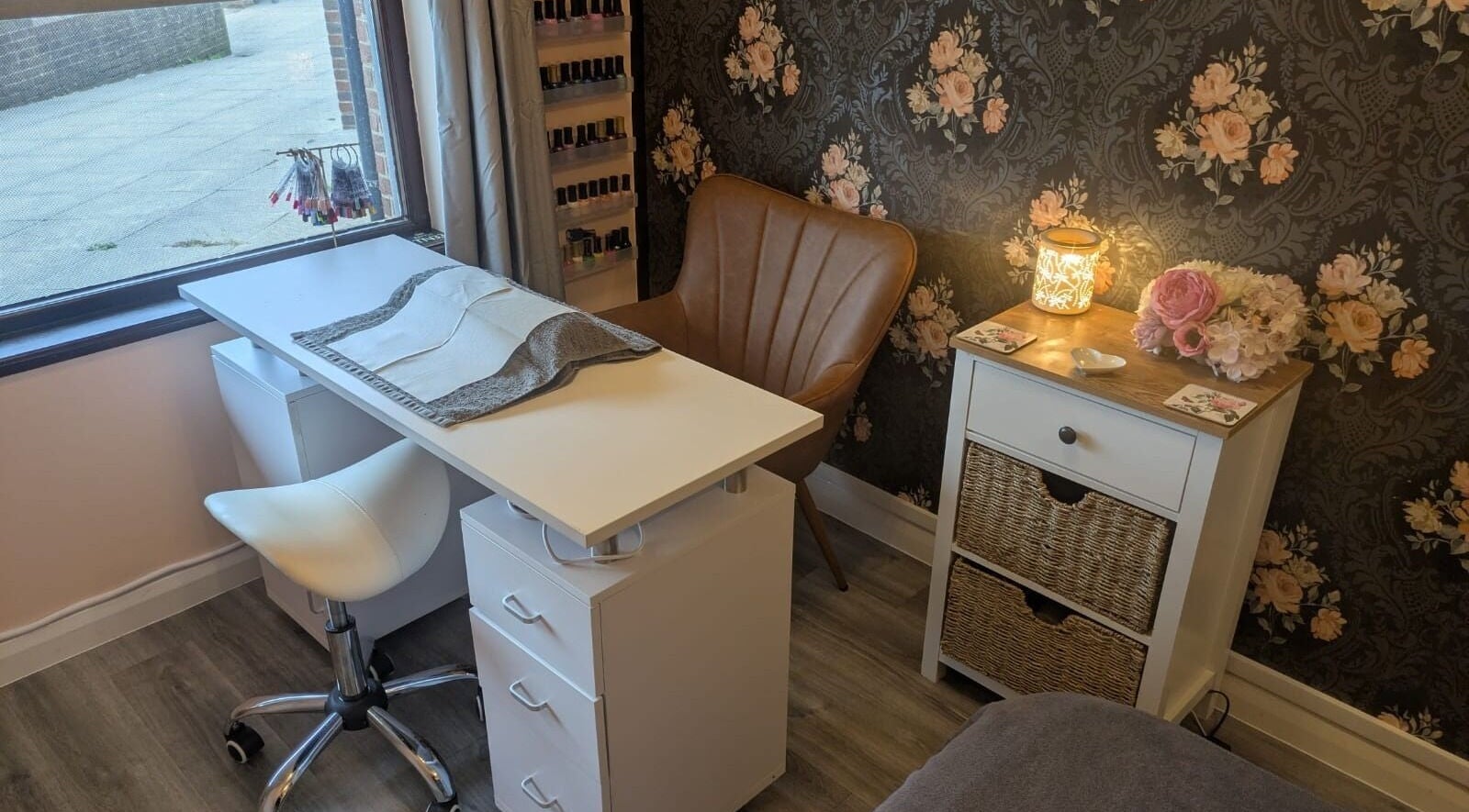 Elegant nail salon setup at The Beauty Box, Battle, England, GB, showcasing a cozy chair and floral decor.
