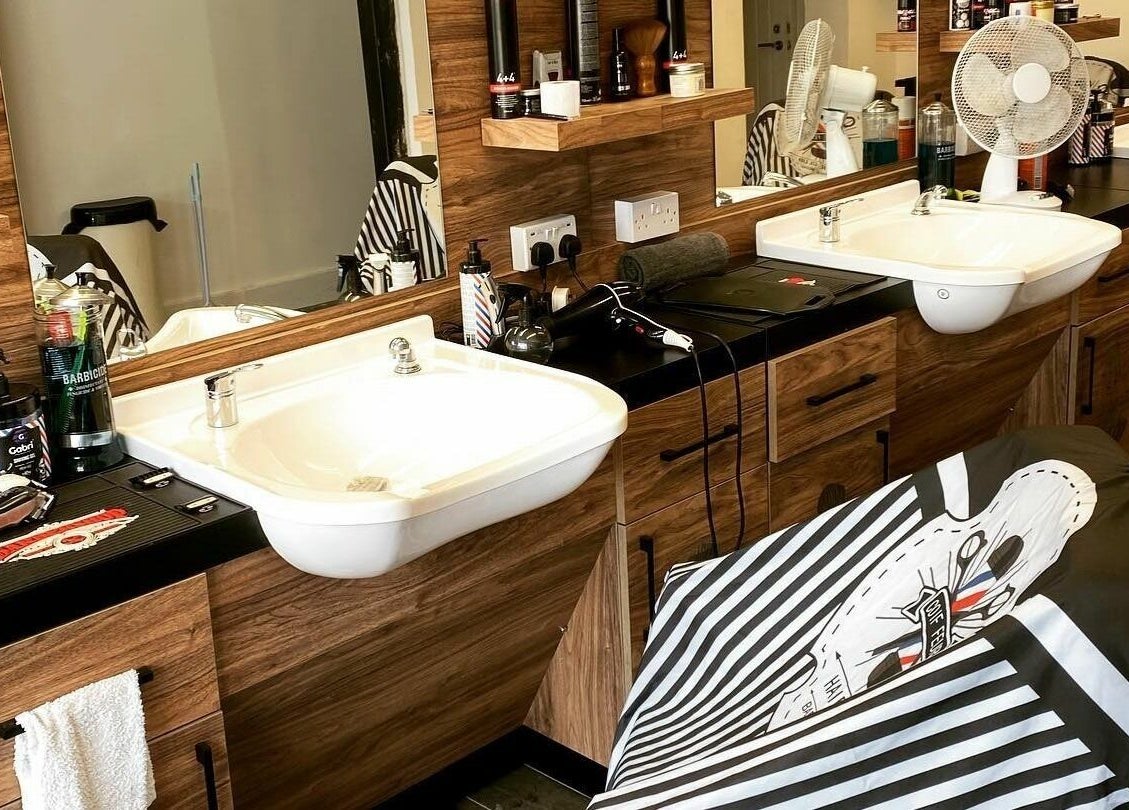 Modern hair styling station at Jorge the Barbershop, Dereham, England, GB. Features sleek sinks and grooming tools.