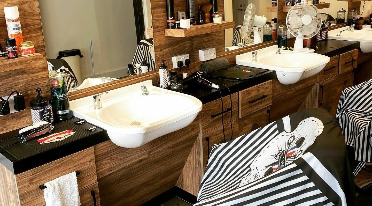Modern hair styling station at Jorge the Barbershop, Dereham, England, GB. Features sleek sinks and grooming tools.