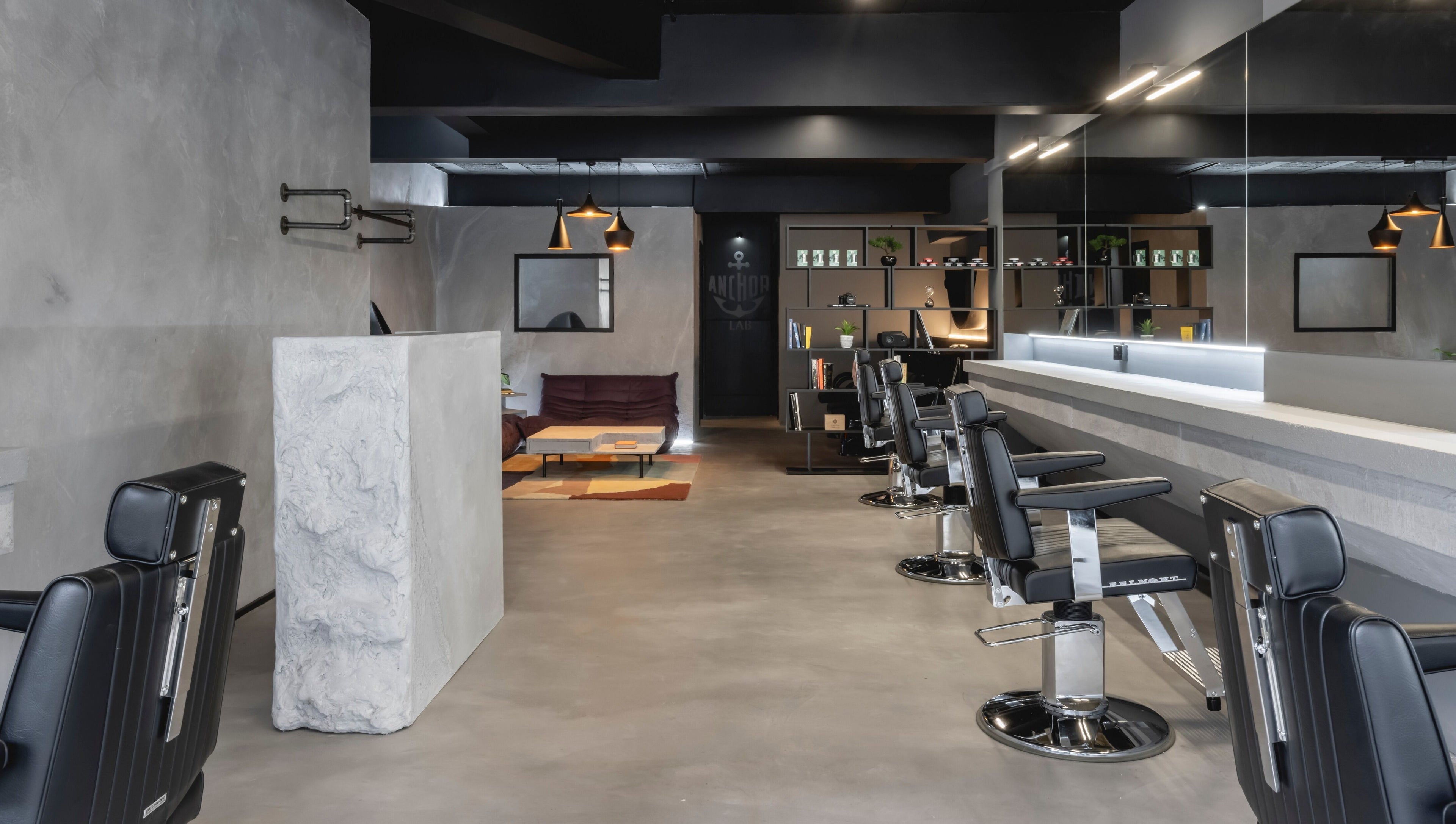 Modern barber chairs at Anchor Lab in London, England, GB, showcasing a sleek and stylish interior design.