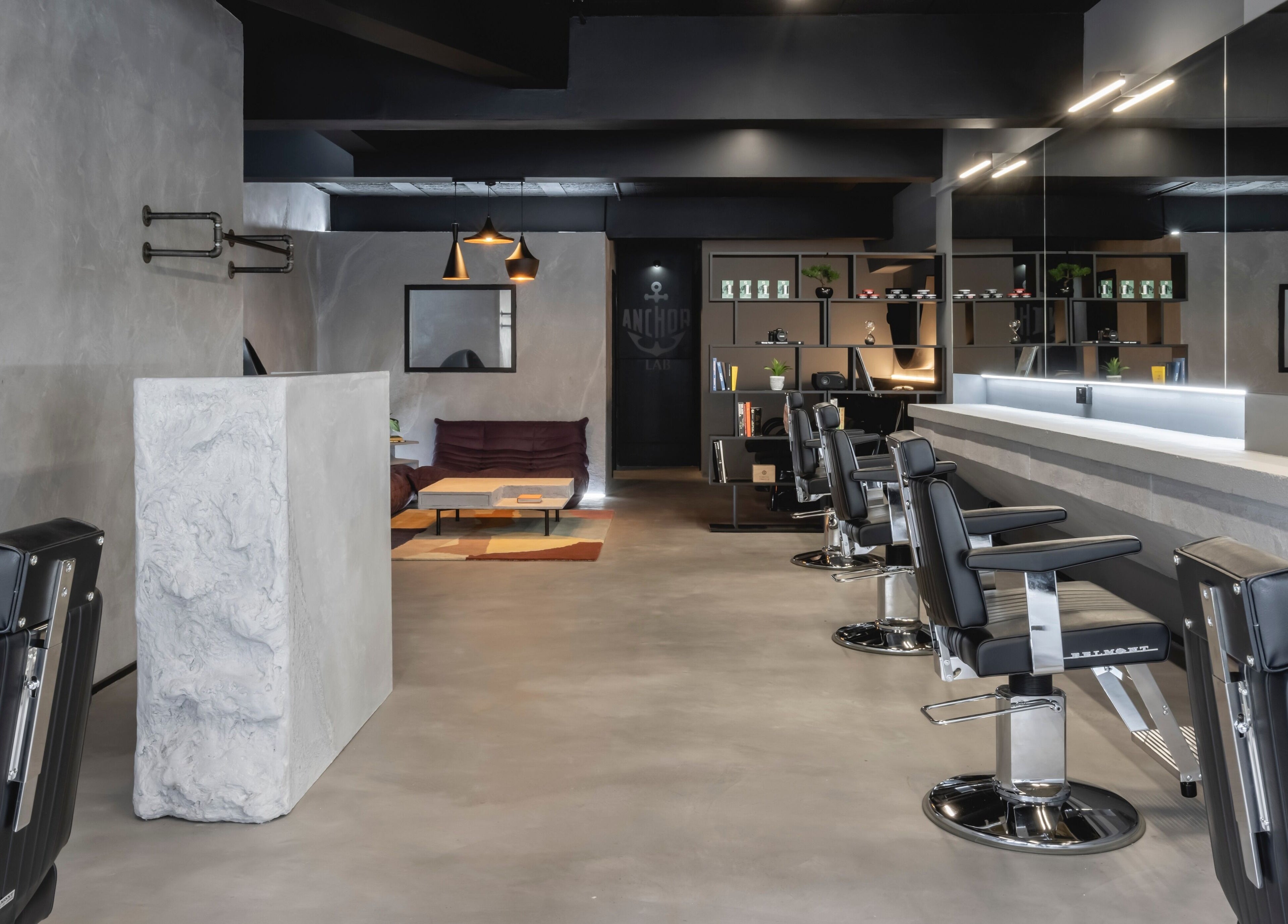 Modern barber chairs at Anchor Lab in London, England, GB, showcasing a sleek and stylish interior design.