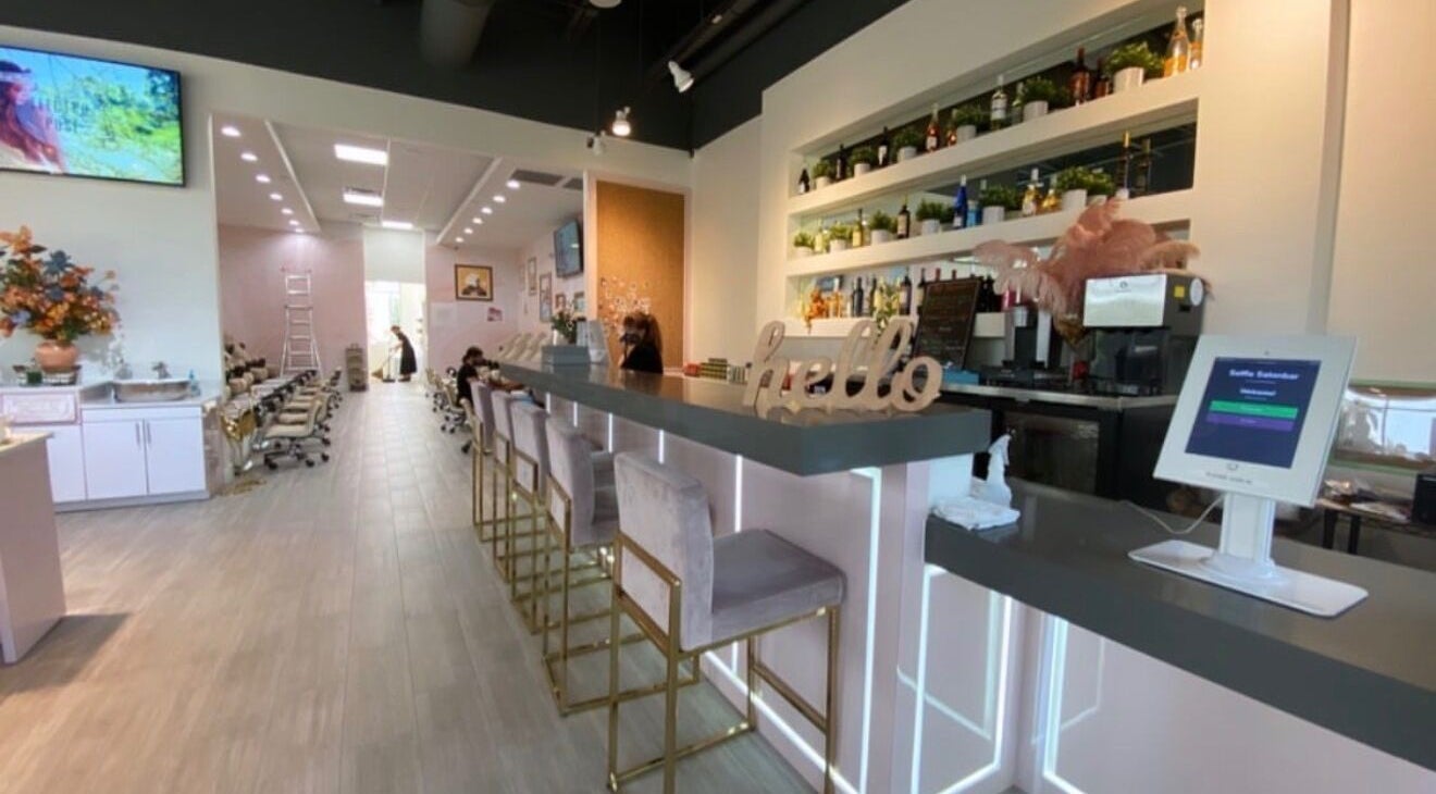 Stylish interior of Selfie Salonbar in Palm Beach Gardens, Florida, US, featuring a modern bar and seating area.