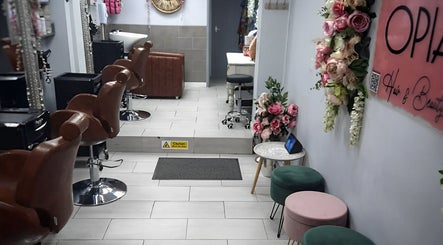 Interior of Jazz at Opia Hair and Beauty in Leek, England, GB showcasing elegant salon chairs and floral decor.
