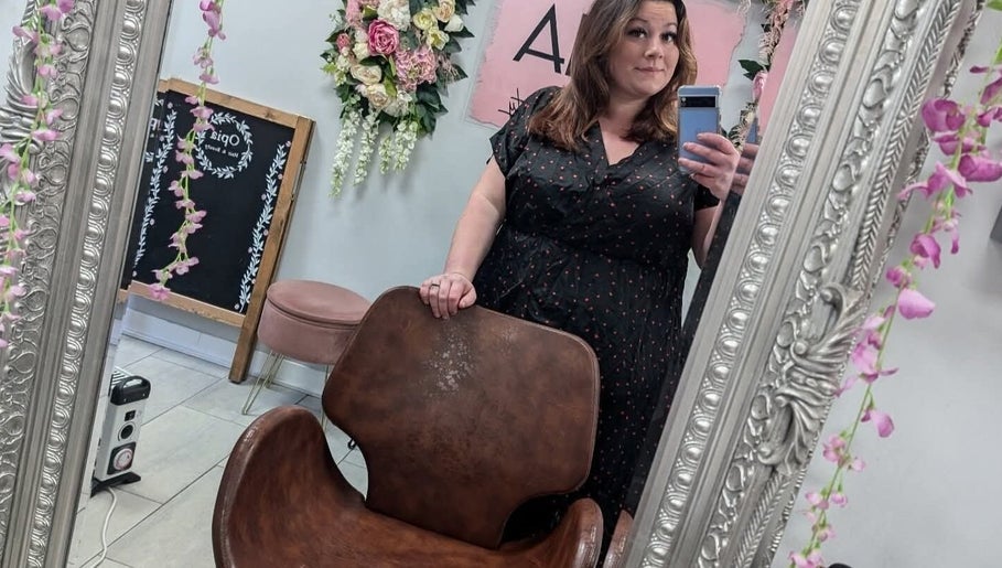 A woman takes a mirror selfie at Jazz at Opia Hair and Beauty, Leek, England, GB, showcasing the salon's decor.