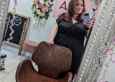 A woman takes a mirror selfie at Jazz at Opia Hair and Beauty, Leek, England, GB, showcasing the salon's decor.