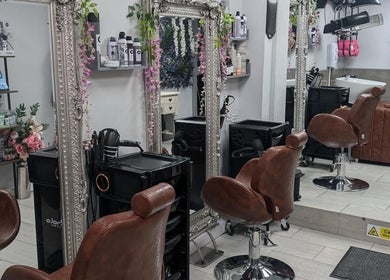 Interior of Jazz at Opia Hair and Beauty in Leek, England, GB, featuring stylish chairs and ornate mirrors.