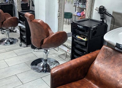 Stylish leather salon chairs at Jazz at Opia Hair and Beauty, Leek, England, GB.
