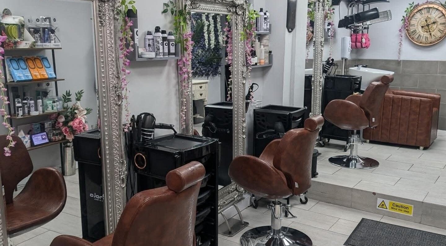 Spacious interior of Jazz at Opia Hair and Beauty in Leek, England, GB with chic chairs and ornate mirrors.