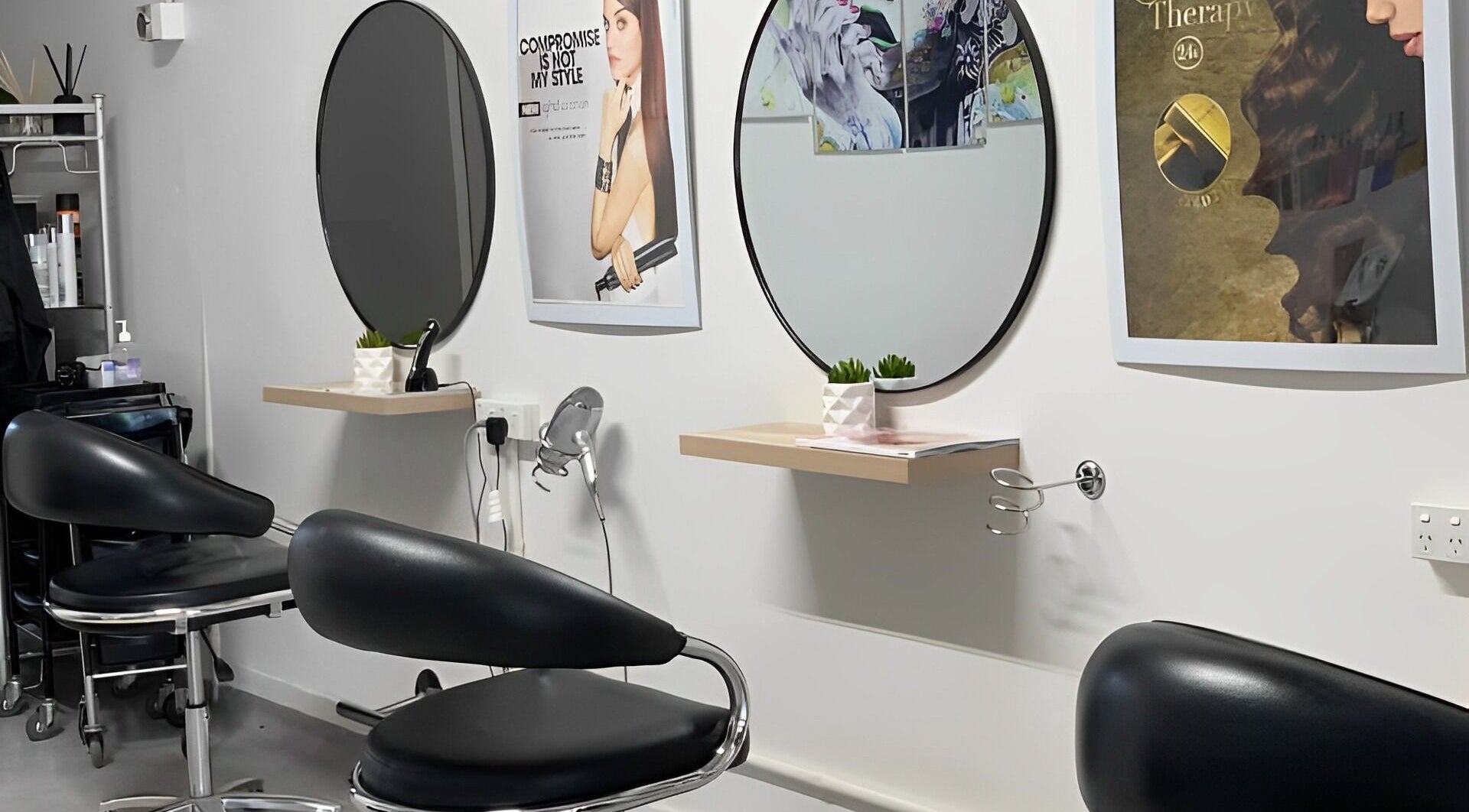 Interior of George Hair and Beauty Salon in Auckland, NZ, featuring modern chairs and round mirrors.