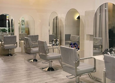 Modern salon interior at Prix Salon, Singapore, Singapore, SG with sleek styling chairs and mirrors.