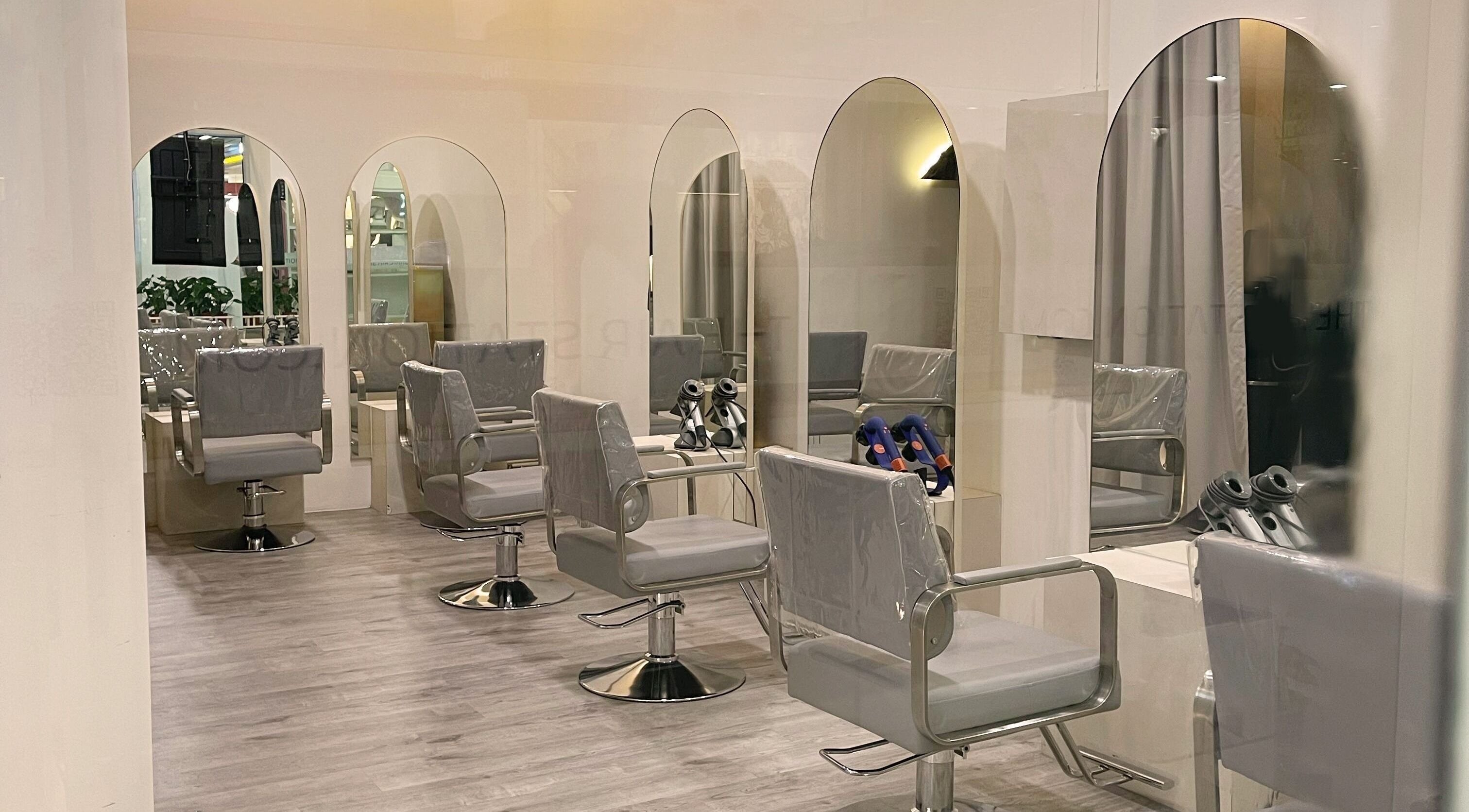 Modern salon interior at Prix Salon, Singapore, Singapore, SG with sleek styling chairs and mirrors.