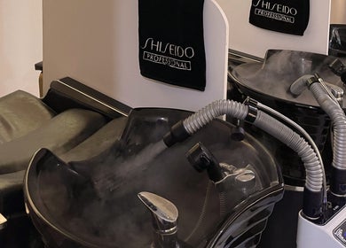 Modern hair wash station at Prix Salon, Singapore, SG with sleek black sinks and professional equipment.