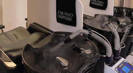 Modern hair wash station at Prix Salon, Singapore, SG with sleek black sinks and professional equipment.