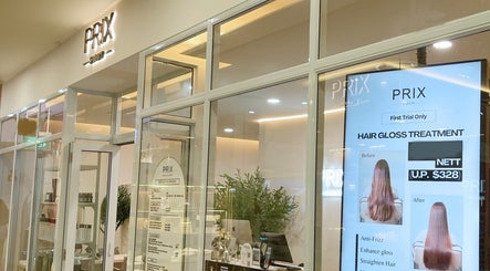 Entrance of Prix Salon in Singapore, showcasing hair gloss treatment poster and modern decor.