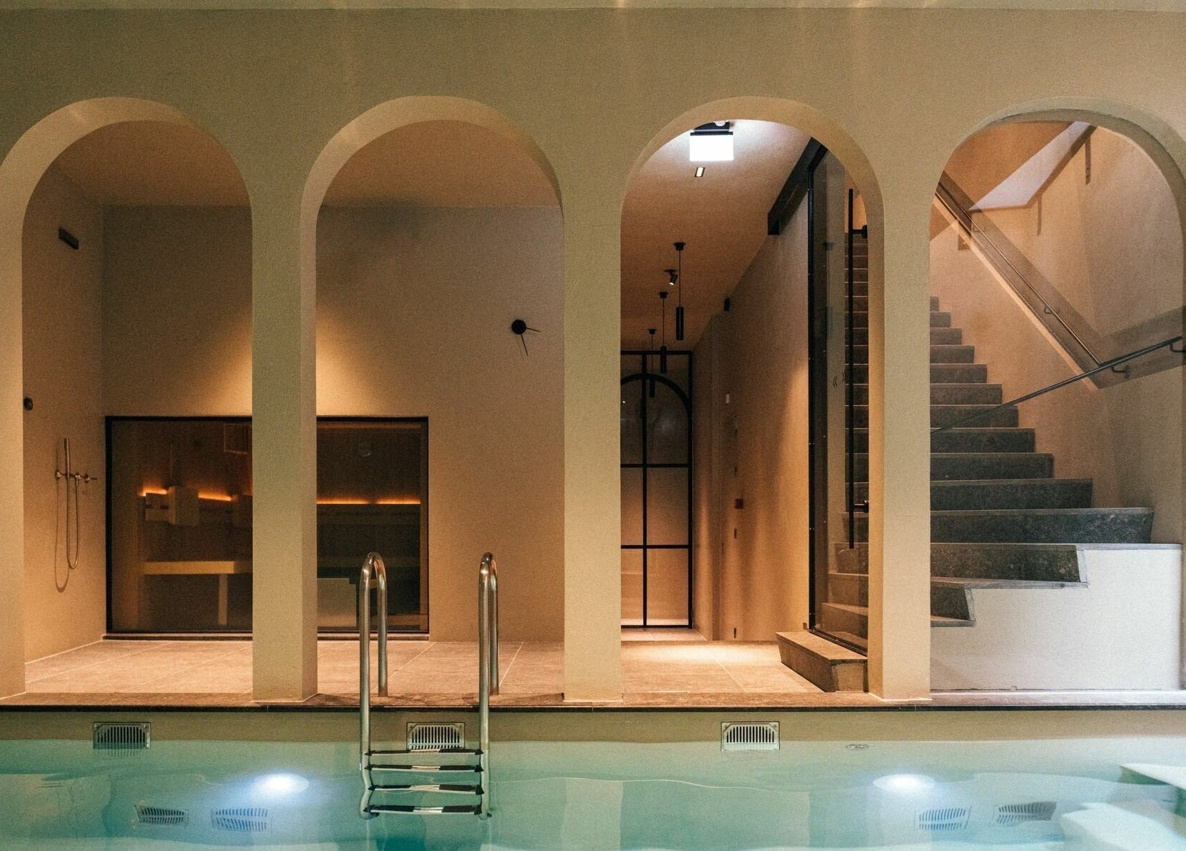 Elegant indoor pool area with arches at Sanctum Spa, Maastricht, Limburg, NL, offering a tranquil ambiance.