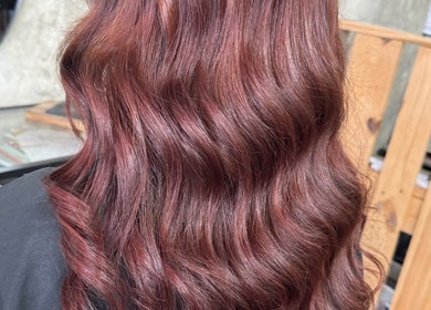 Elegant auburn hair waves styled at Roux - Jessica in Irlam, England, GB. Perfect for sophisticated looks.