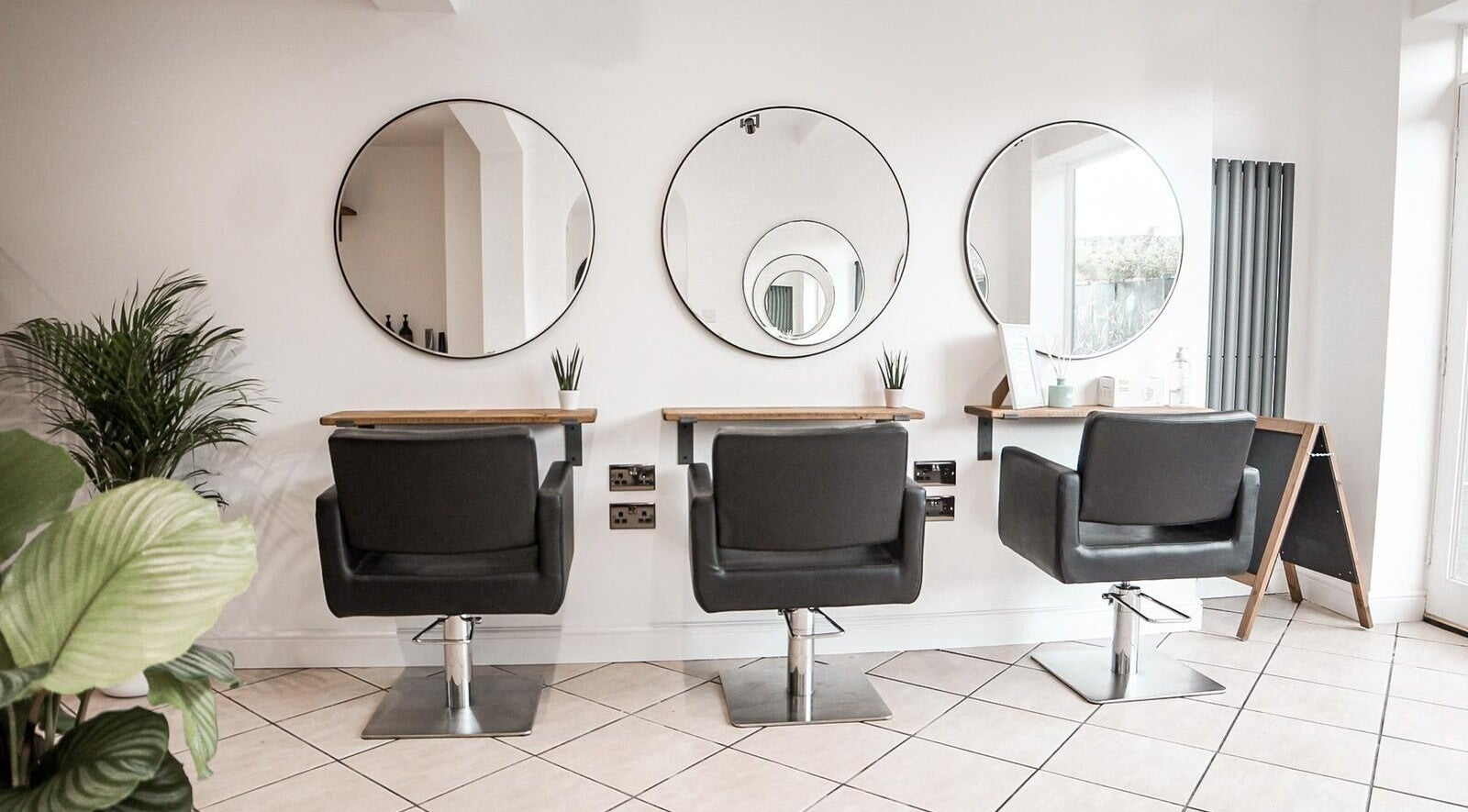 Modern salon chairs and mirrors at Cleaver & Willow Hair, Loughborough, England, GB.