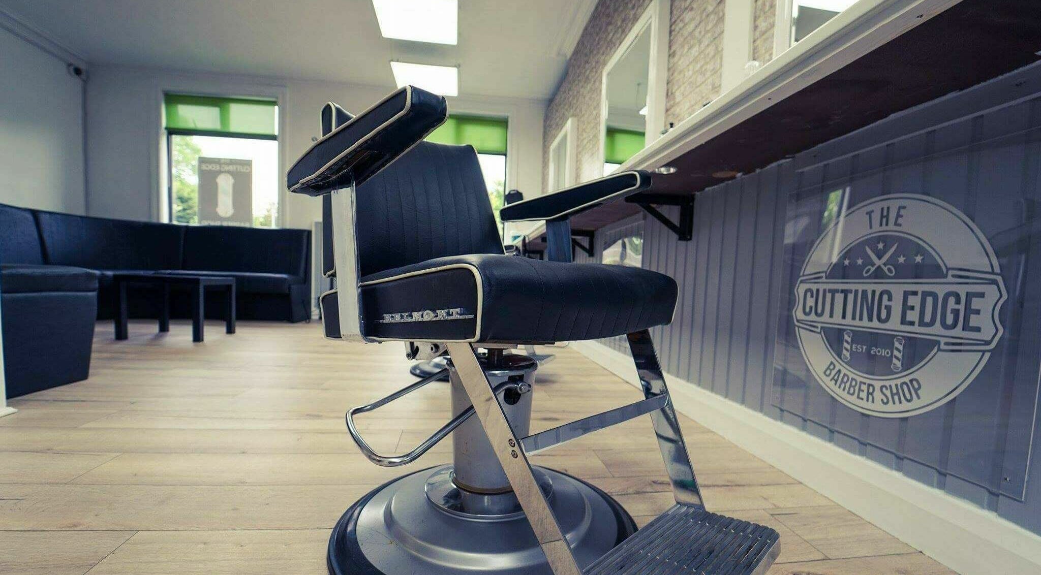 The Cutting Edge Barber Shop interior in Belfast, Northern Ireland, GB, featuring modern barber chair and decor.