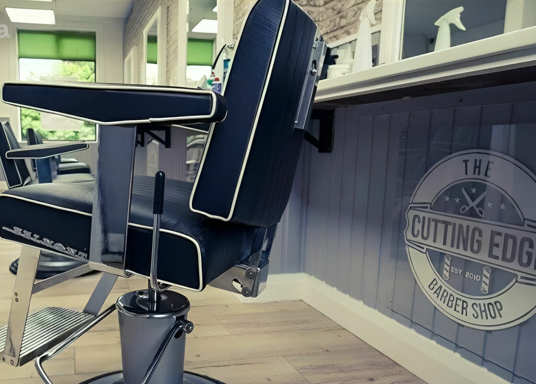 Sleek barber chair at The Cutting Edge Barber Shop, Belfast, Northern Ireland, GB, offering a modern grooming experience.