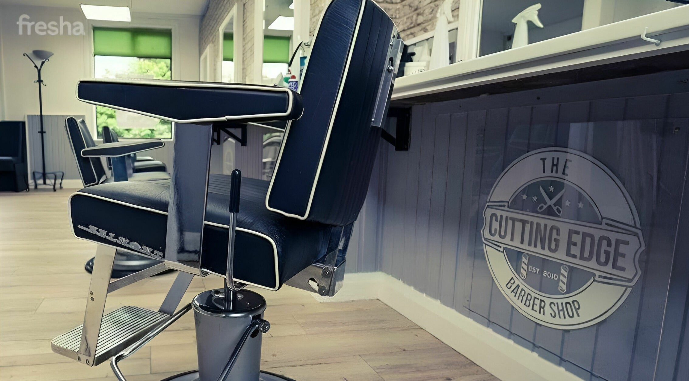 Sleek barber chair at The Cutting Edge Barber Shop, Belfast, Northern Ireland, GB, offering a modern grooming experience.