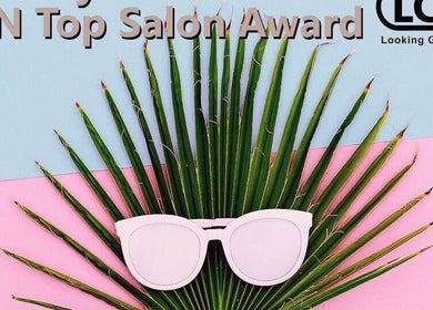 Award-winning decor at The Nail Room, Cape Town, Western Cape, ZA with sunglasses on palm leaf.