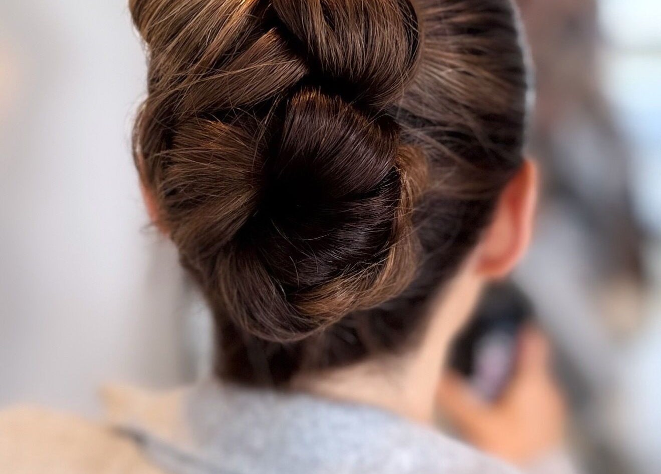 Elegant braided updo hairstyle at THE BOUTIQUE by MLR in Barry, Wales, GB, showcasing salon's styling expertise.