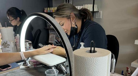 Nail technician at Buhf Beauty Boutique in Langley City, BC, CA, meticulously manicuring a client's nails.