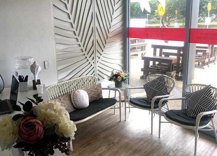 Inviting lounge area at The Waxxx Pot, Maroochydore, Queensland, AU, featuring elegant seating and floral decor.