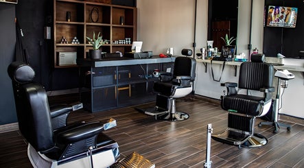 Contemporary barber chairs at Barbería H, Tijuana, Baja California, MX, showcasing sleek design and comfort.