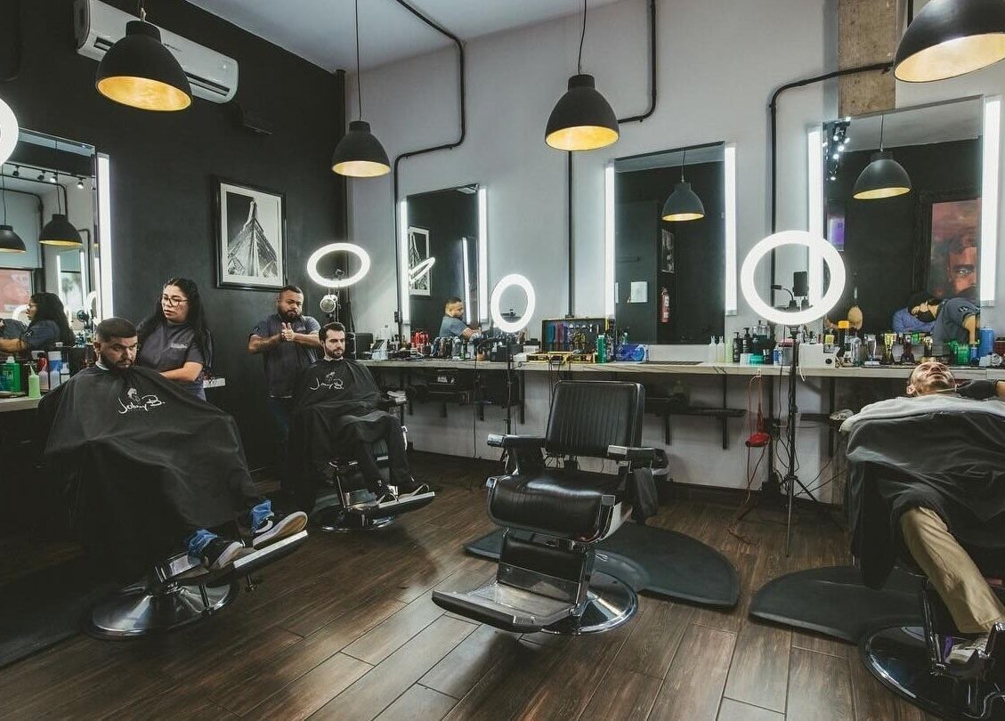 Inside view of Barbería H in Tijuana, Baja California, MX with modern barber chairs and stylish decor.