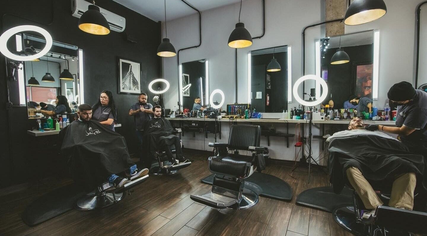 Inside view of Barbería H in Tijuana, Baja California, MX with modern barber chairs and stylish decor.