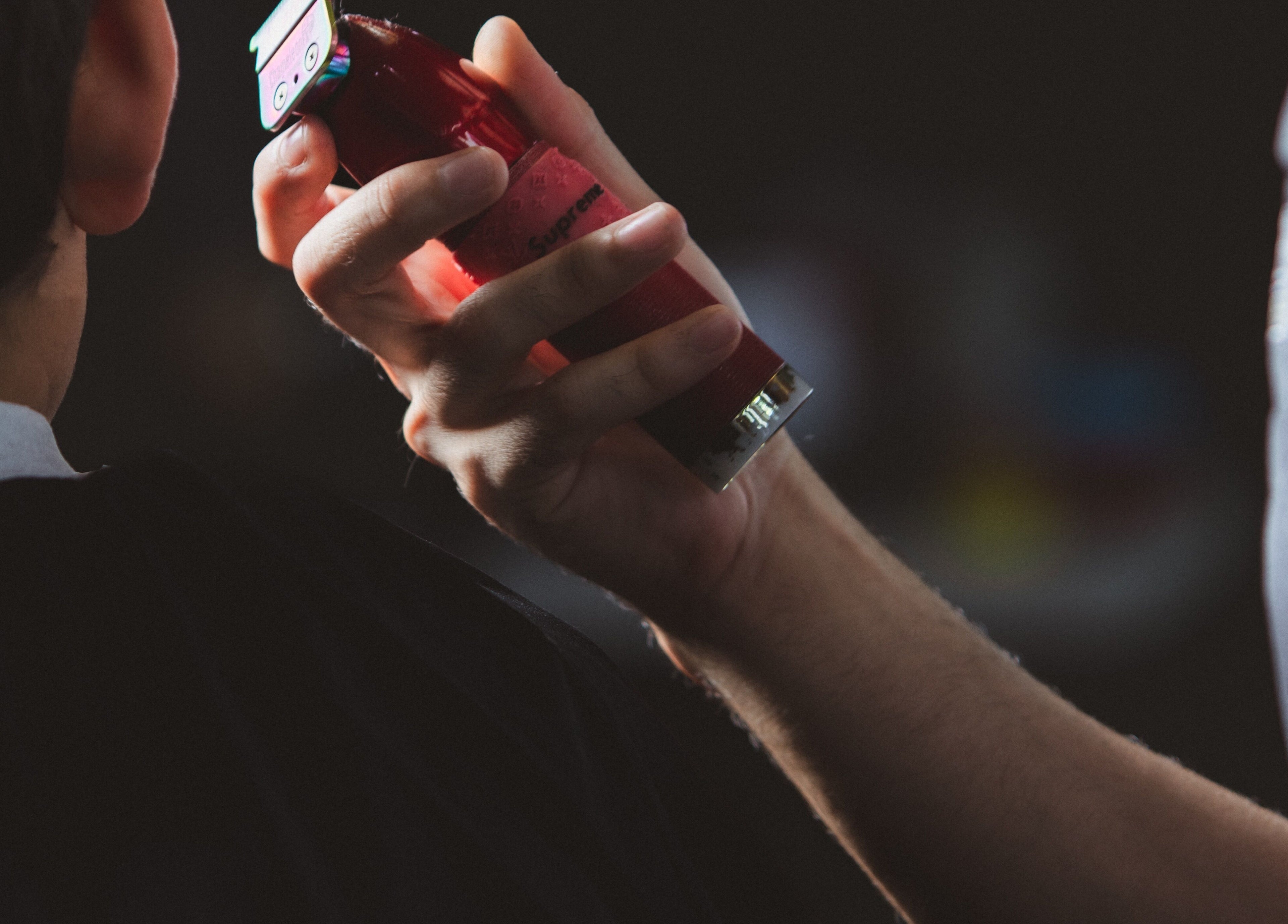 Barber using clippers at Barbería H, Tijuana, Baja California, MX.