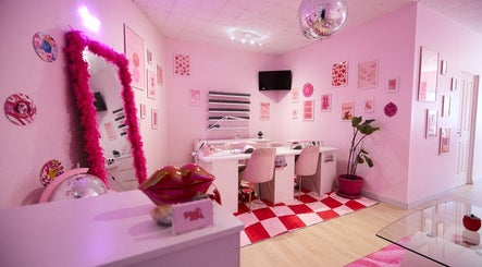 Stylish interior of Groove Salon in Newtown, New South Wales, AU featuring pink decor and elegant seating.