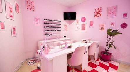Stylish pink-themed nail salon at Groove Salon, Newtown, New South Wales, AU. Modern decor and elegant seating.