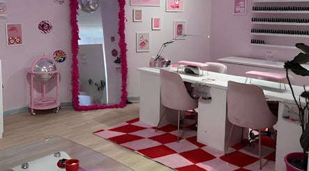 Groove Salon's stylish pink interior in Newtown, New South Wales, AU, with modern nail stations and vibrant decor.