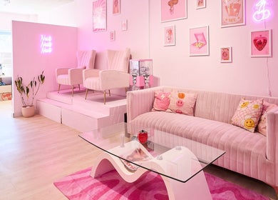 Stylish pink interior at Groove Salon, Newtown, NSW, AU with modern seating and vibrant decor.