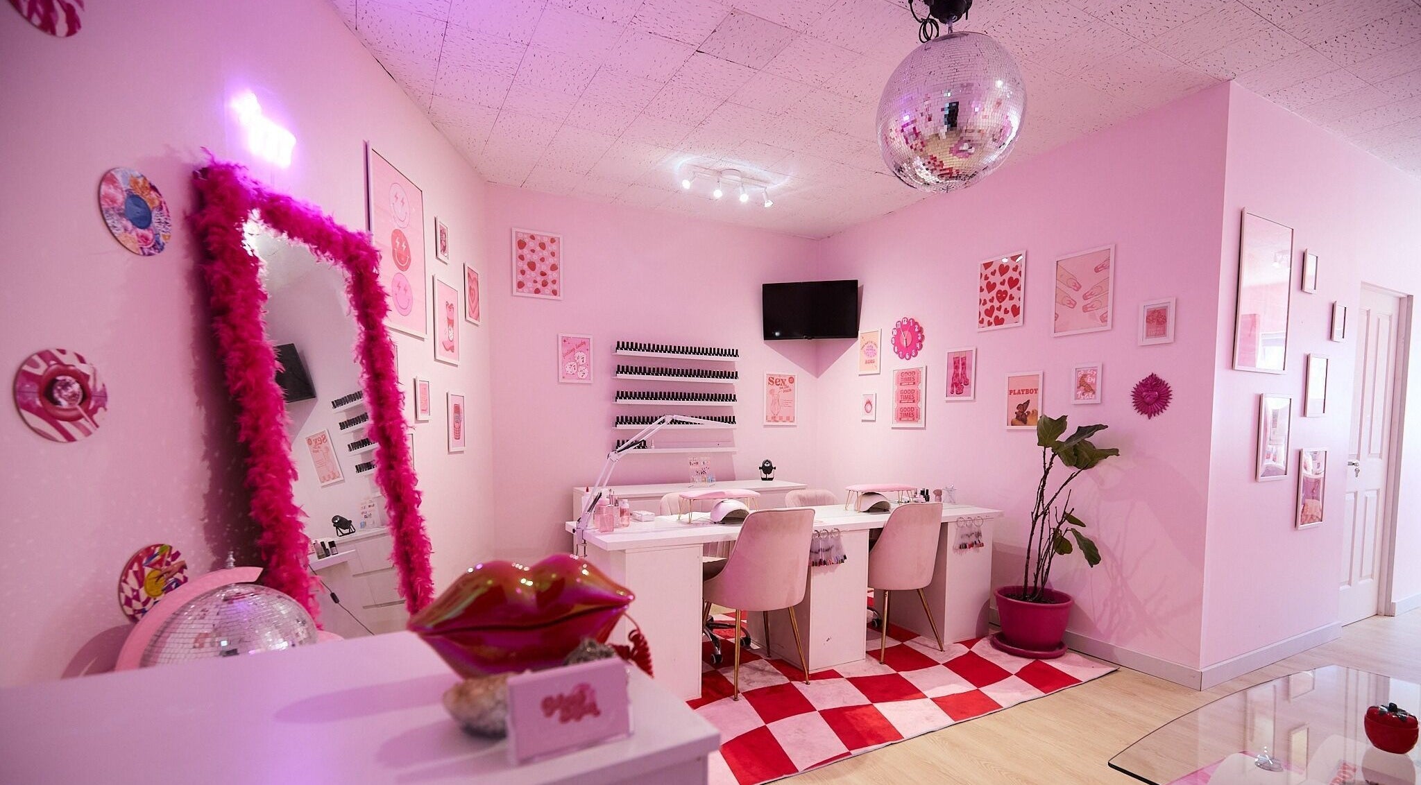 Chic pink interior of Groove Salon, Newtown, New South Wales, AU showcasing vibrant decor and cozy seating.