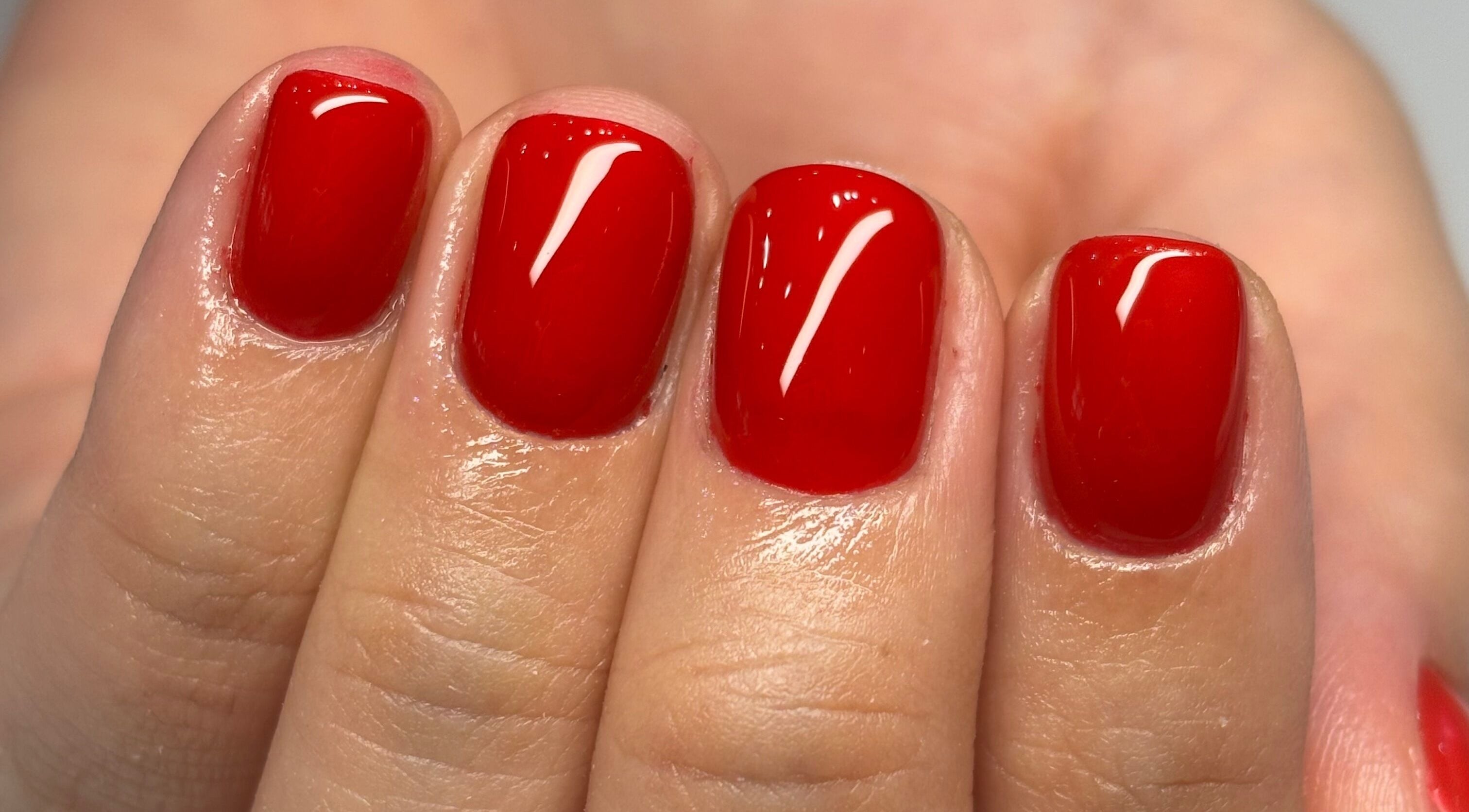 Vibrant red manicure at Groove Salon, Newtown, New South Wales, AU showcasing elegant nail art.