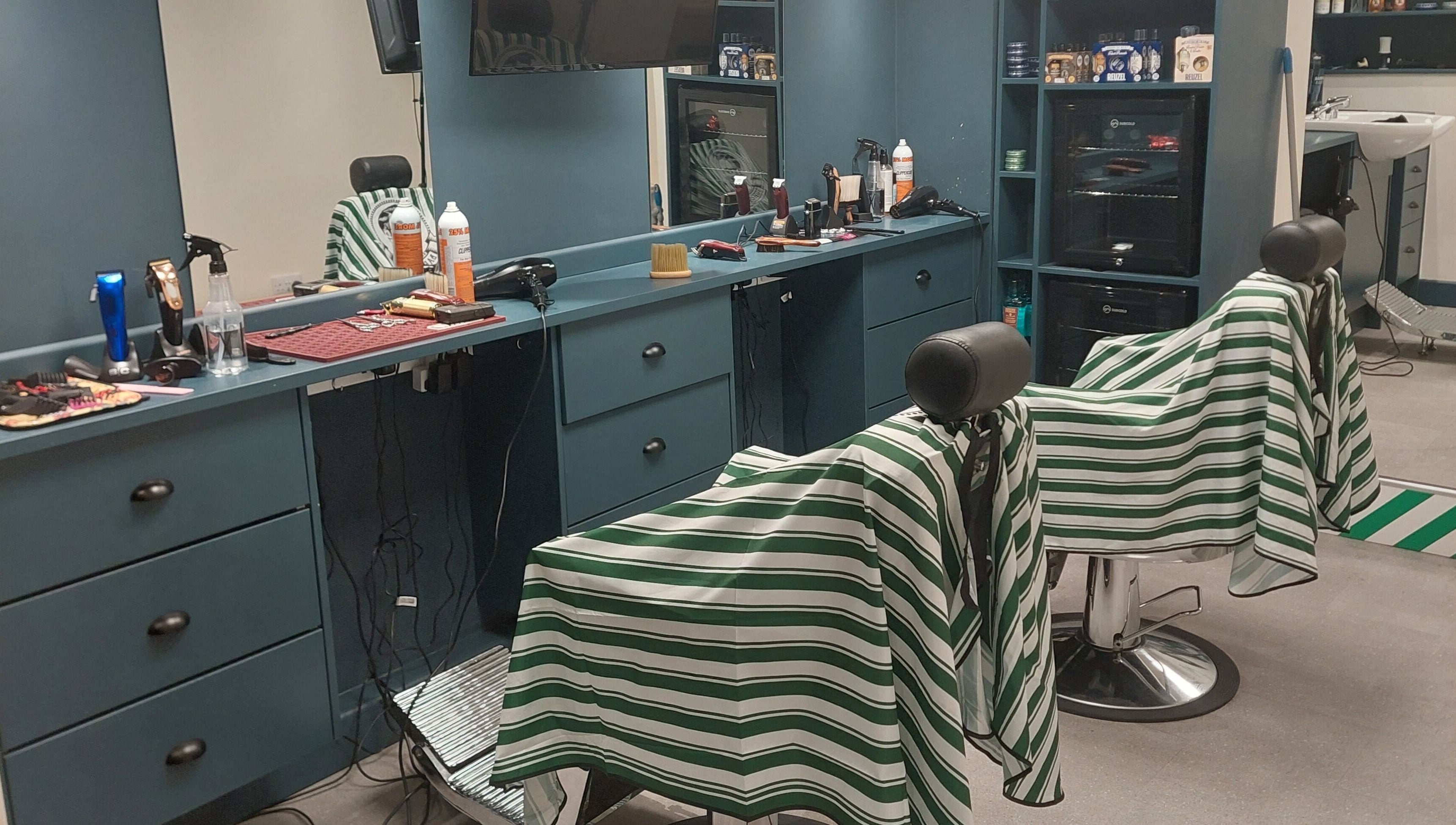 Modern interior of The Yorkshire Barbers, Birstall, England, GB featuring stylish barber chairs and grooming tools.