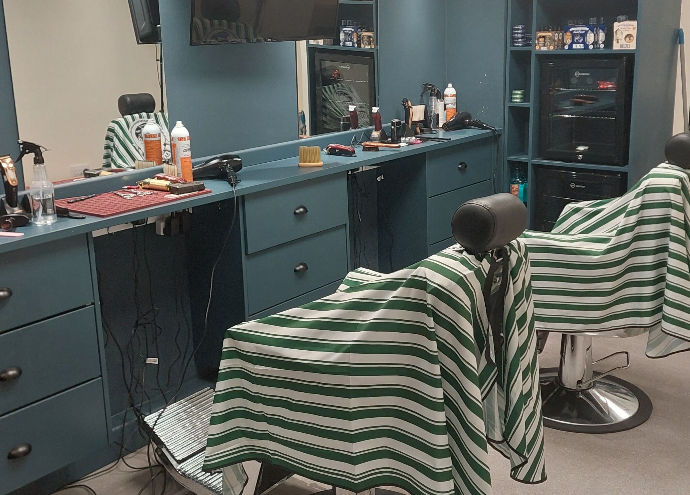 Modern interior of The Yorkshire Barbers, Birstall, England, GB featuring stylish barber chairs and grooming tools.