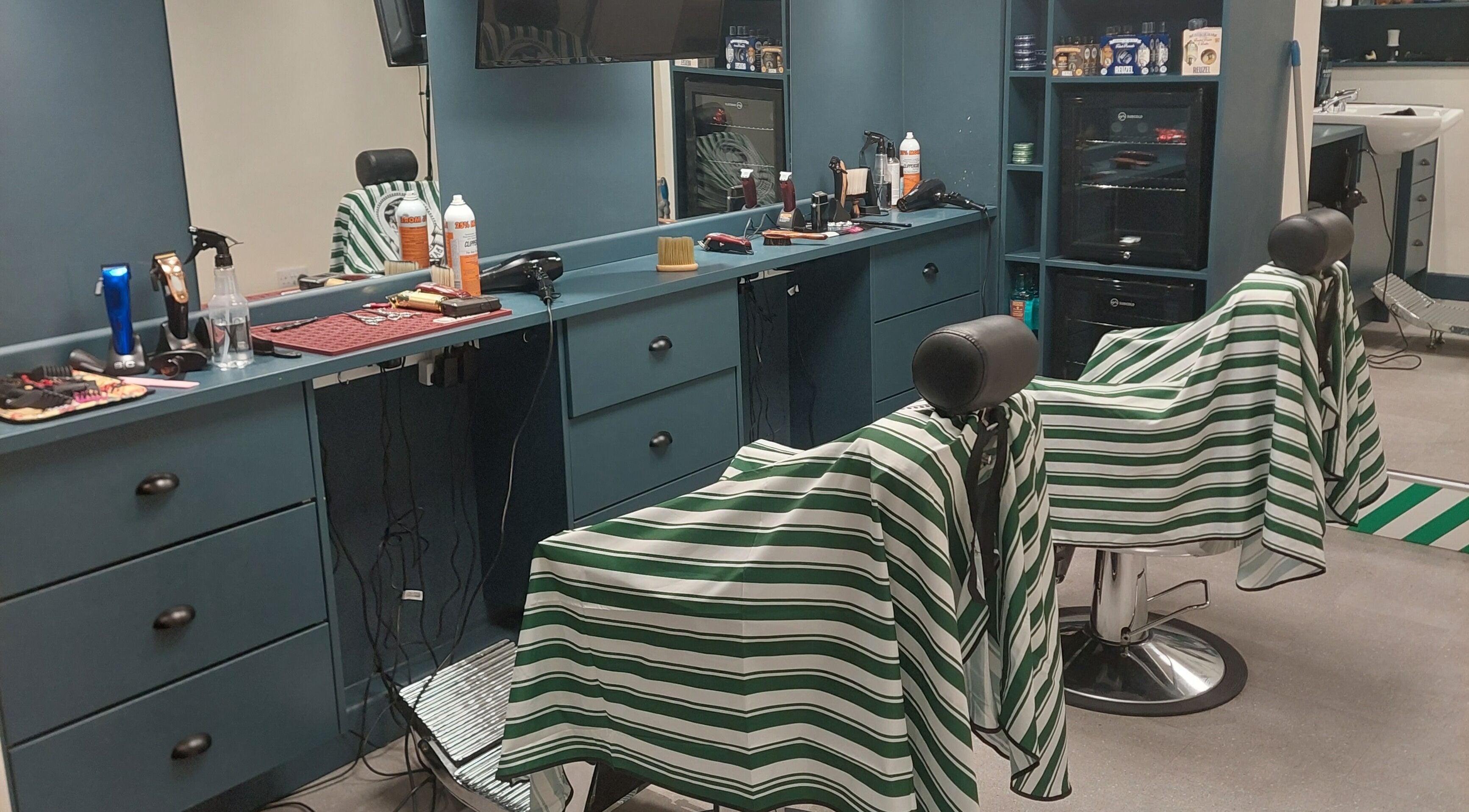 Modern interior of The Yorkshire Barbers, Birstall, England, GB featuring stylish barber chairs and grooming tools.
