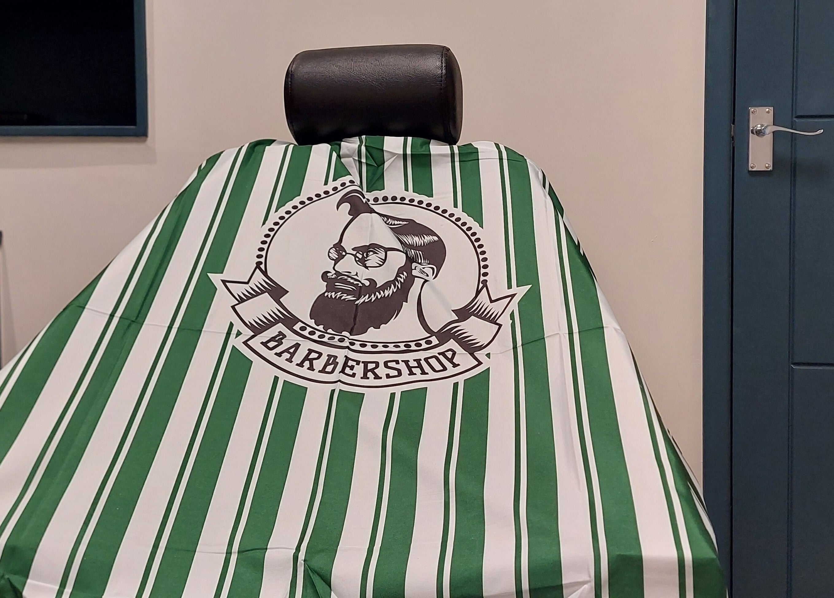 Stylish barber chair at The Yorkshire Barbers in Birstall, England, GB, featuring a striped cover.