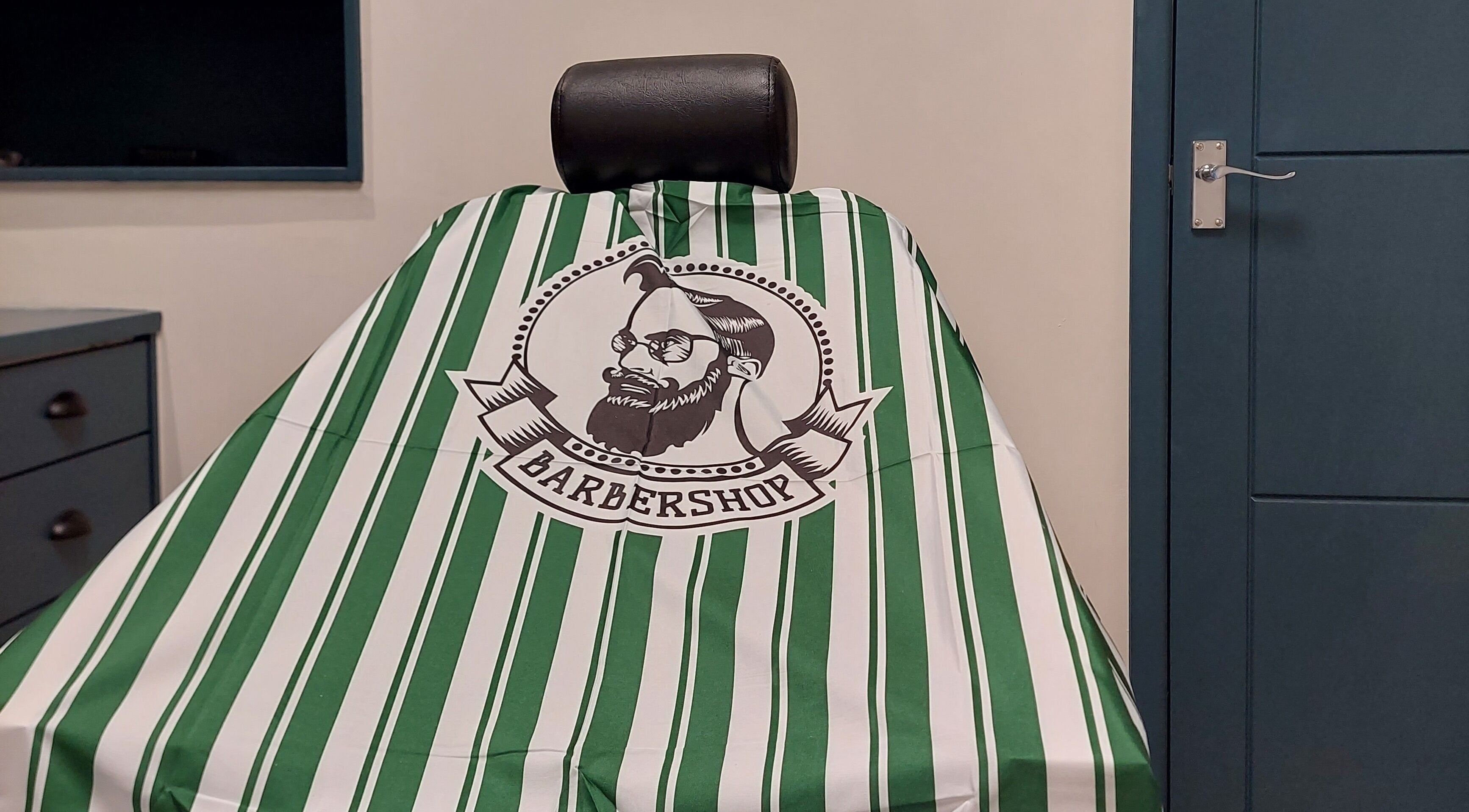 Stylish barber chair at The Yorkshire Barbers in Birstall, England, GB, featuring a striped cover.