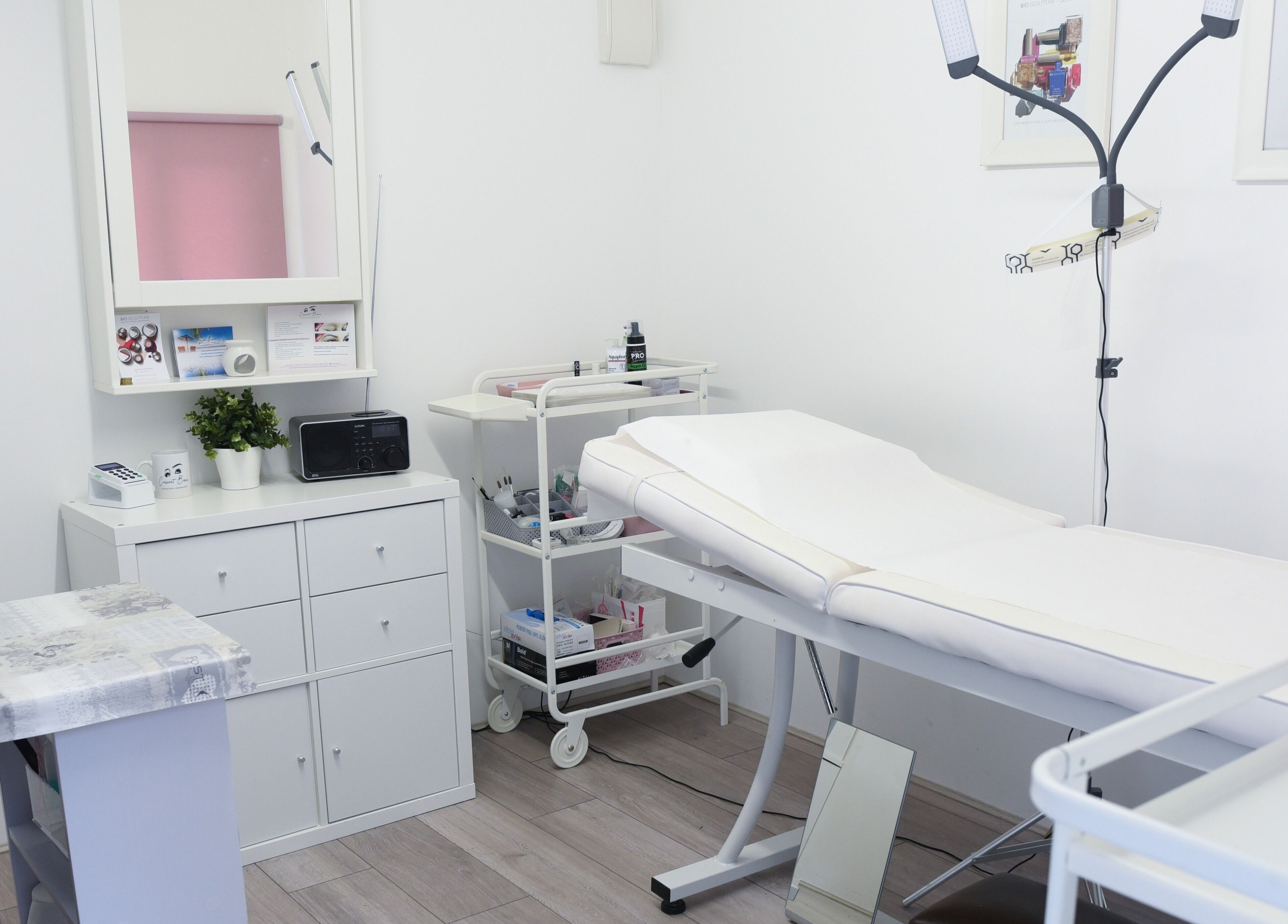 Modern treatment room at Crescent Brows in Lambourn, England, GB, showcasing white decor and sleek furnishings.