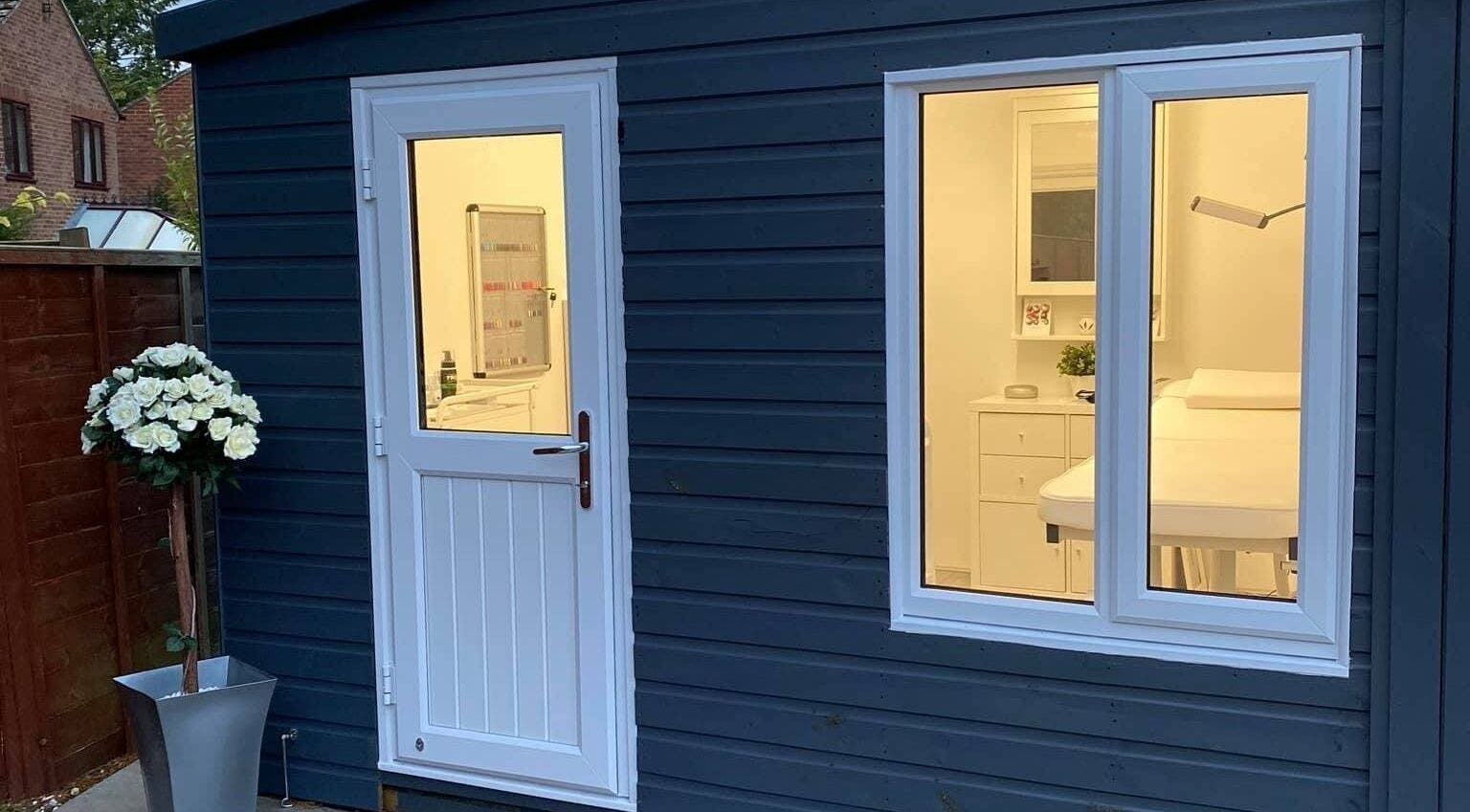 Inviting exterior of Crescent Brows salon, Lambourn, England, GB with elegant white door and window lighting.