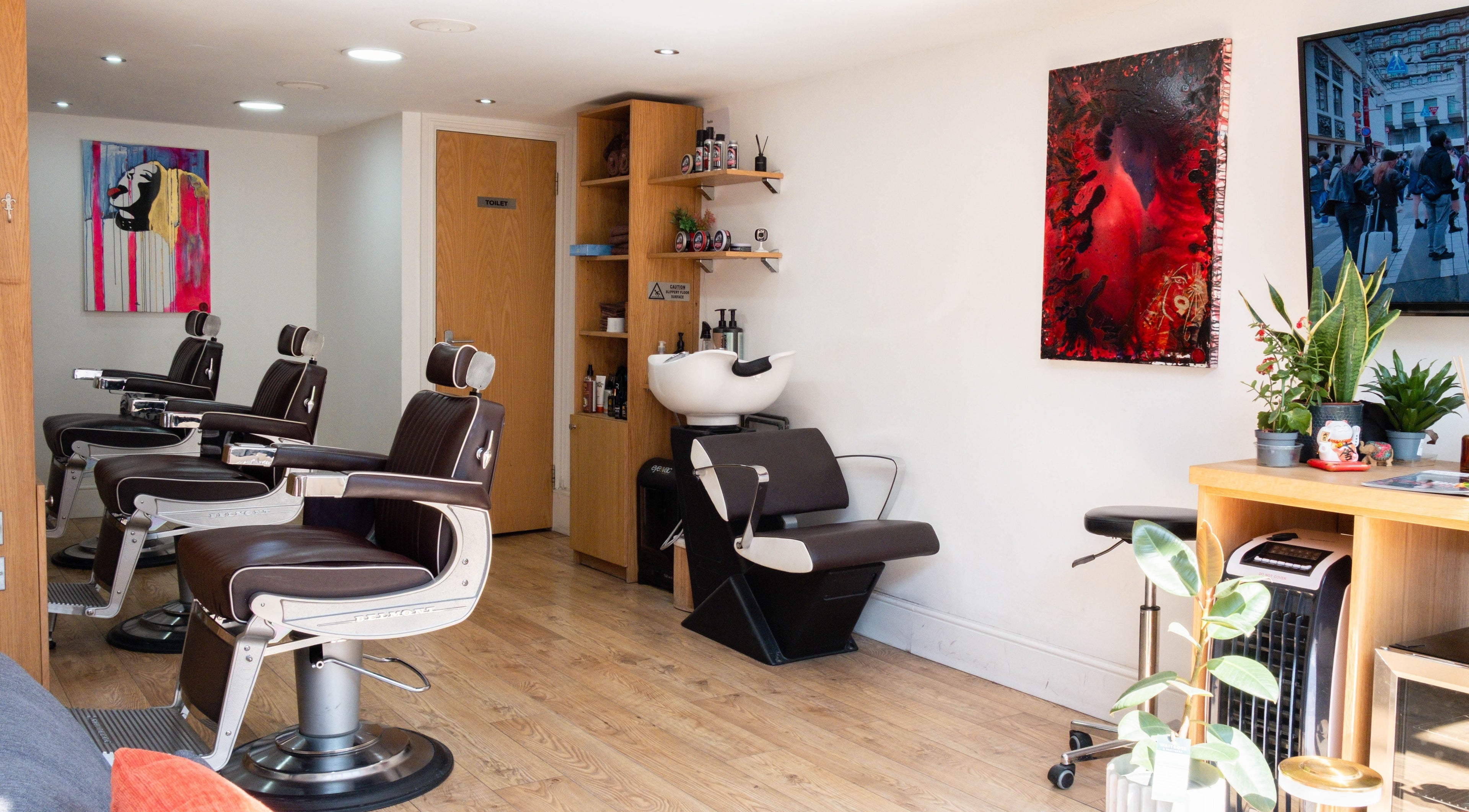 Interior of Barbershop 55 in London, England, GB with stylish barber chairs and modern decor.