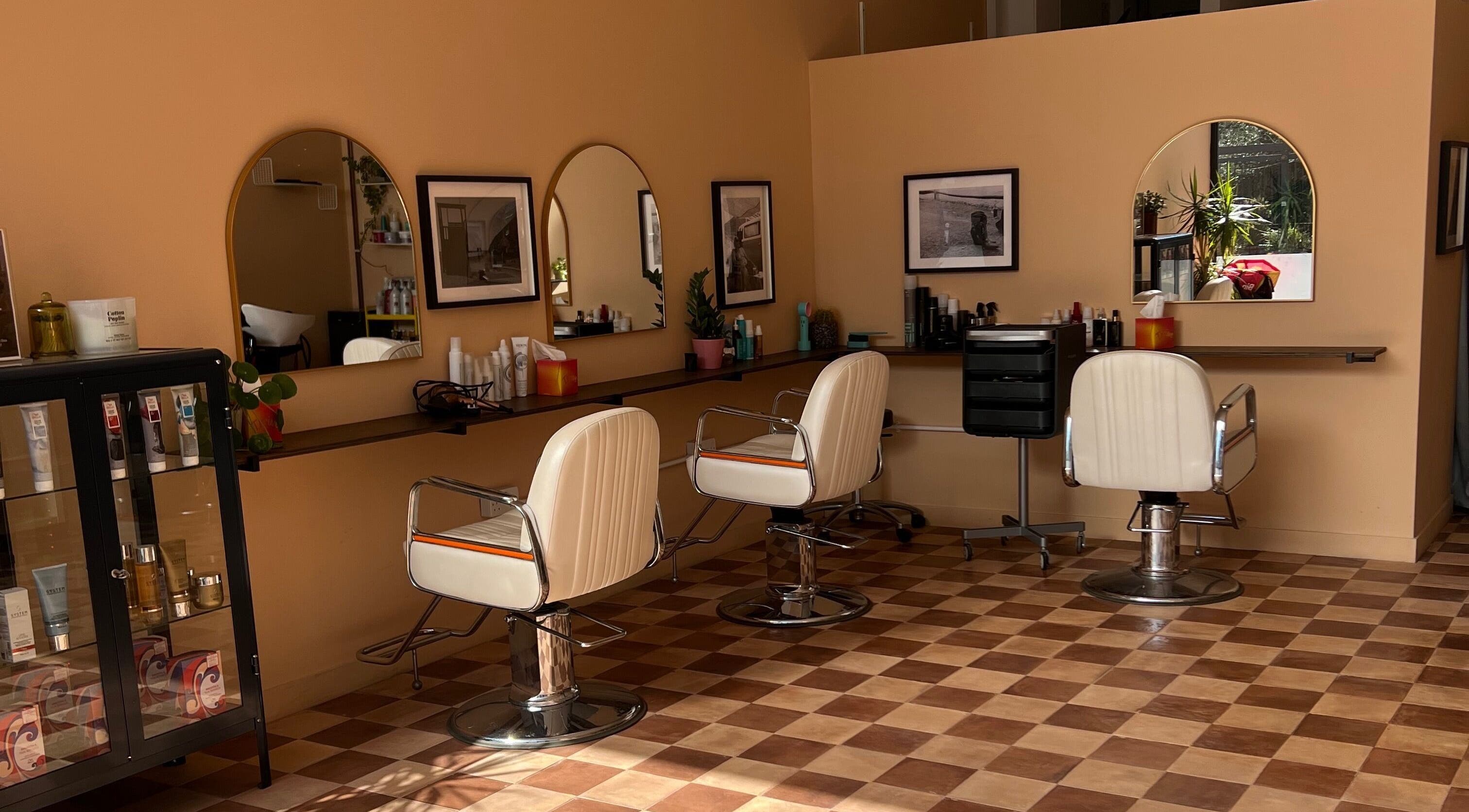Maxine's stylish salon interior with white chairs and decor in Southend-on-Sea, England, GB.