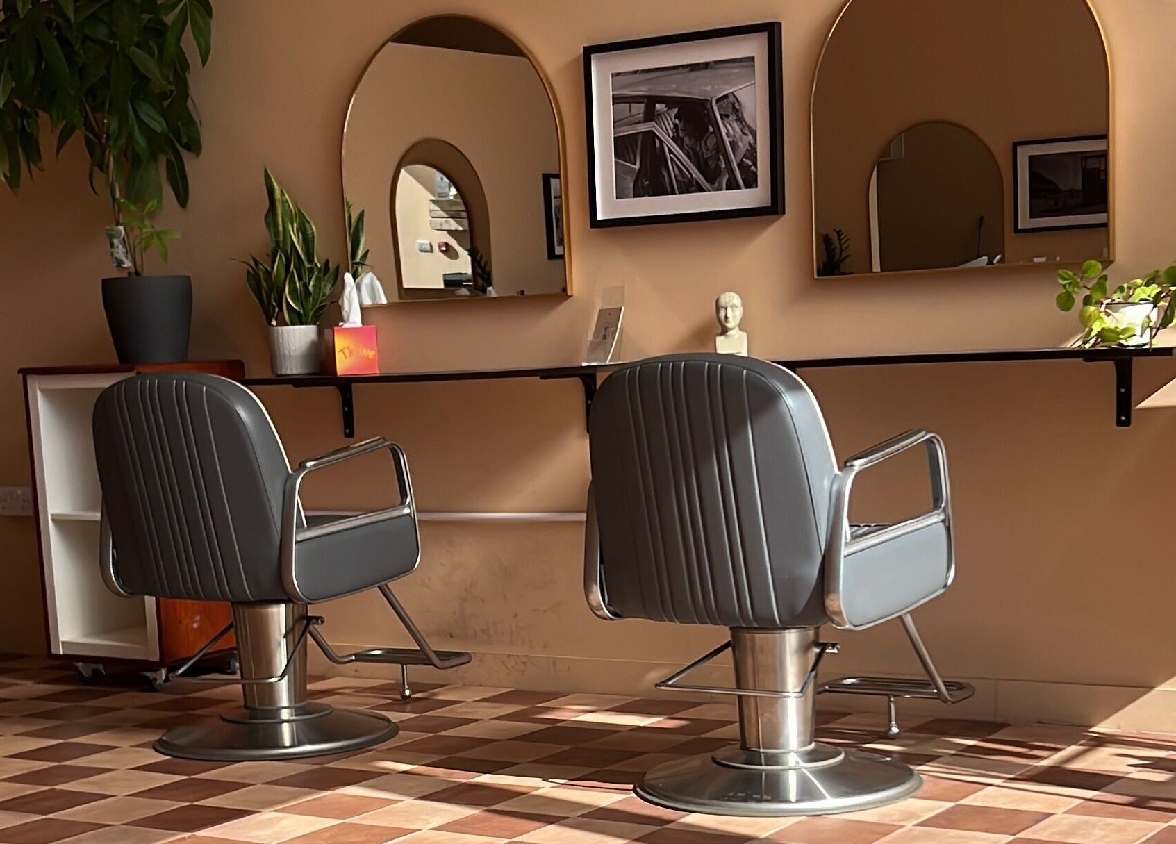 Modern salon interior at Maxine in Southend-on-Sea, England, GB featuring stylish chairs and mirrors.