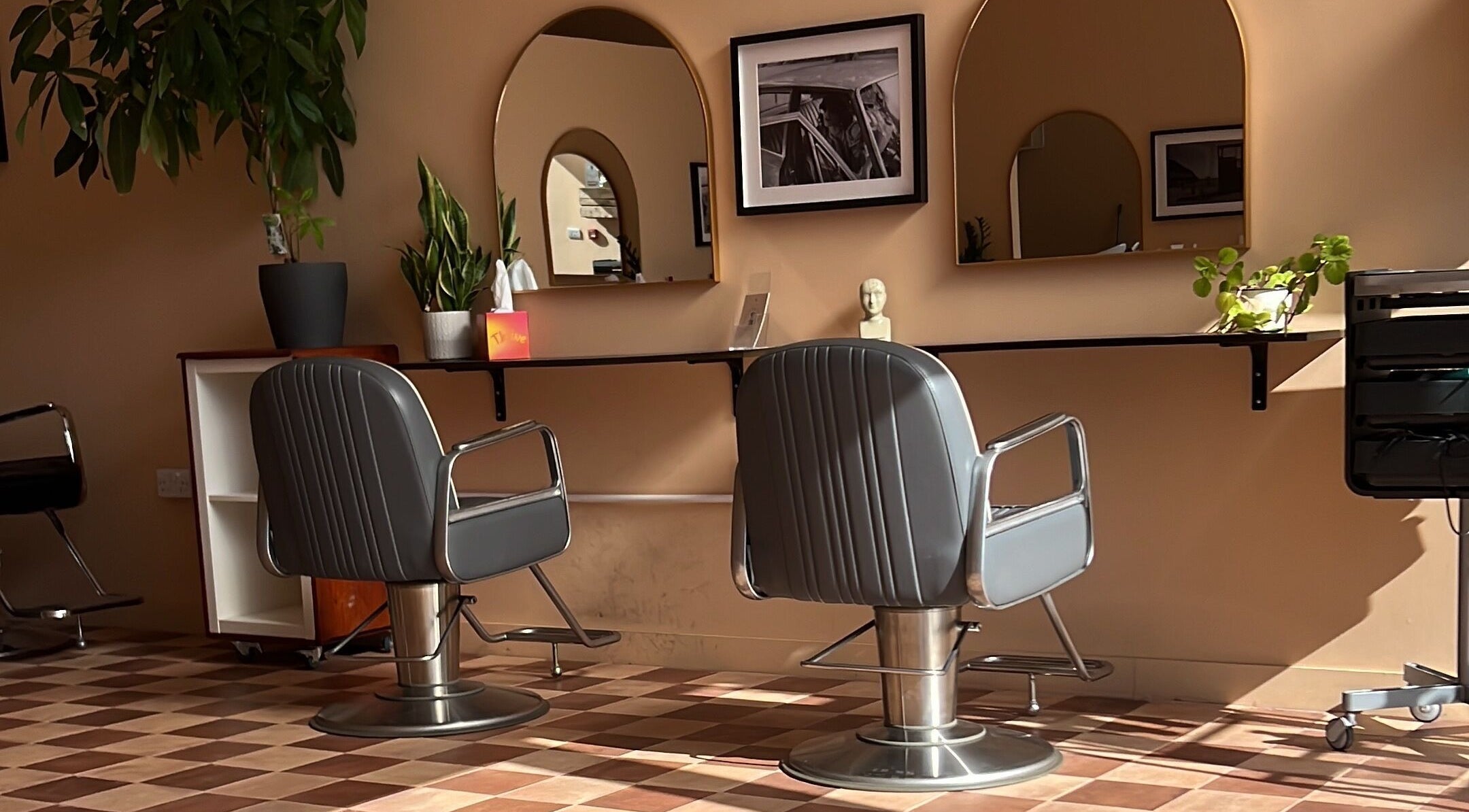 Modern salon interior at Maxine in Southend-on-Sea, England, GB featuring stylish chairs and mirrors.