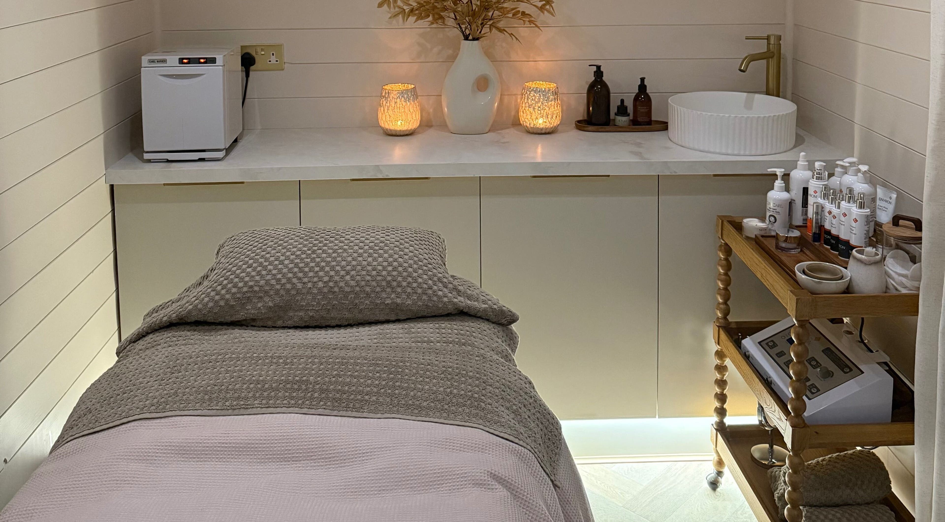 Relaxing treatment room at Lume Skin Cabin, East Morton, England, GB with spa bed and ambient lighting.